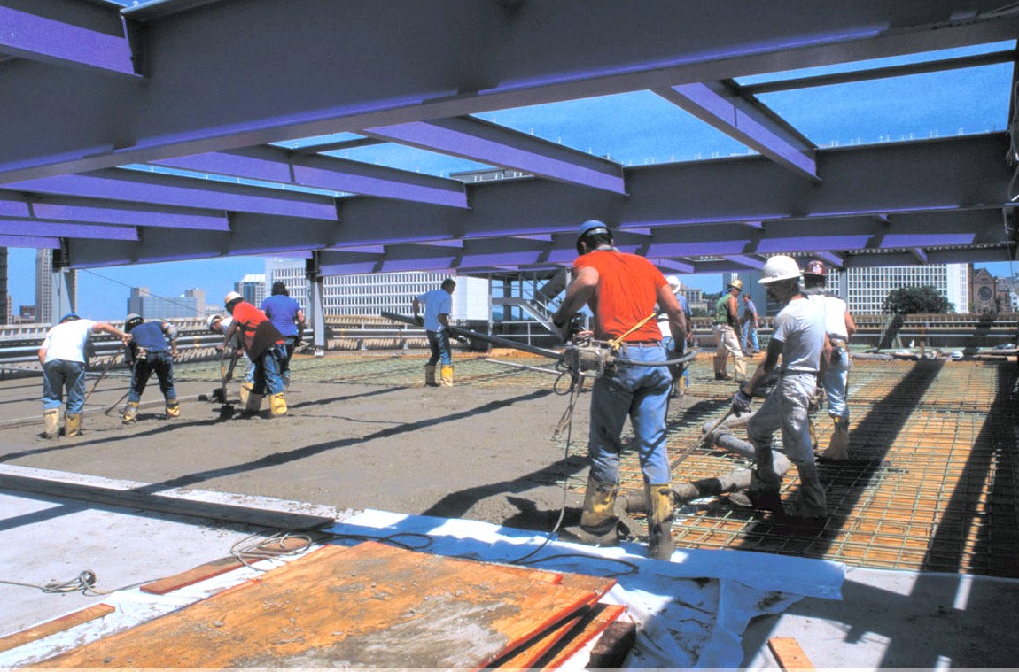 men working on a cement floor