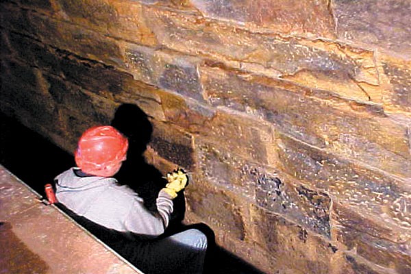 man fixing a brick wall