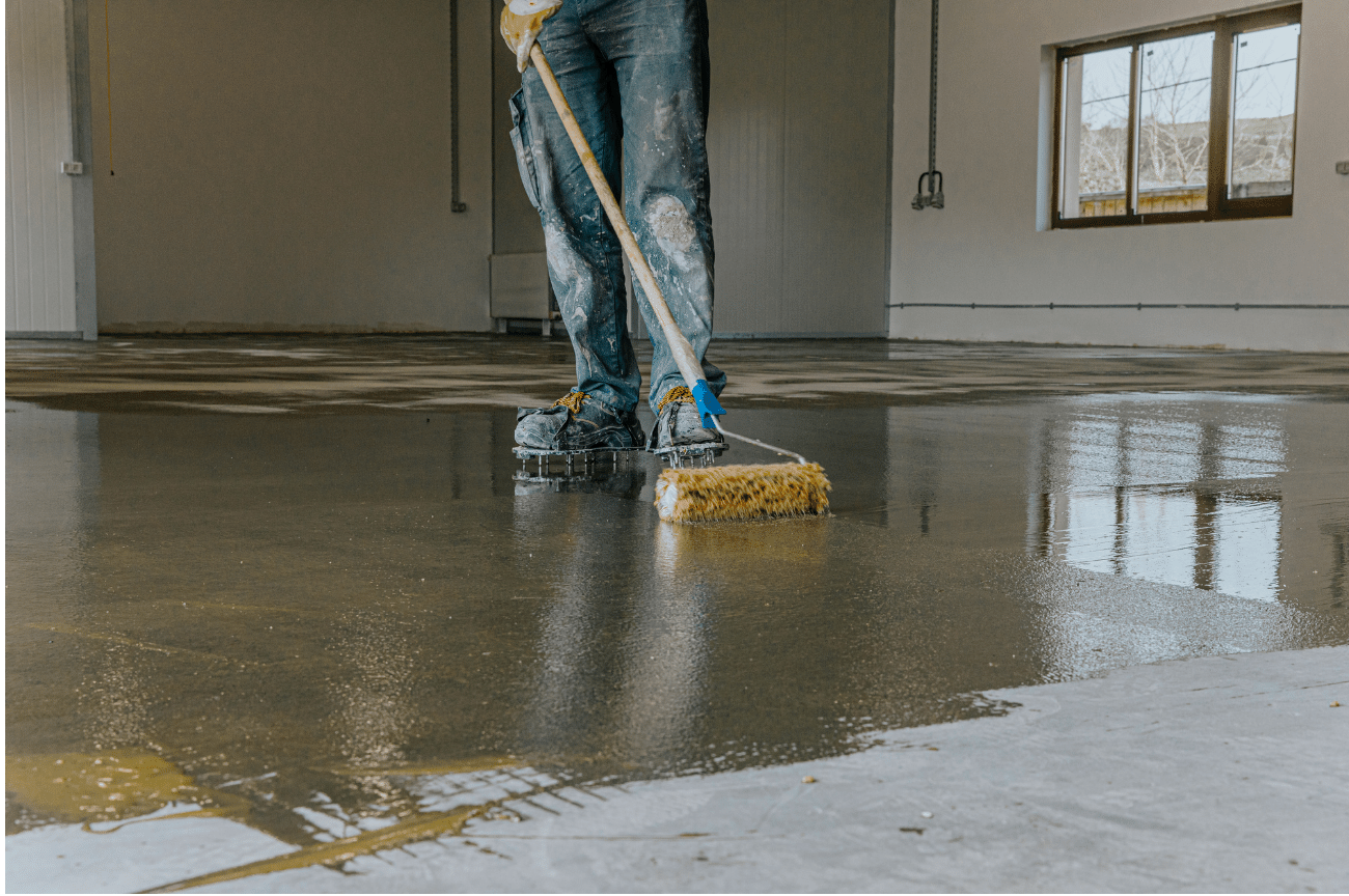 What is Concrete Restoration and Why is it Important: Man adding sealant